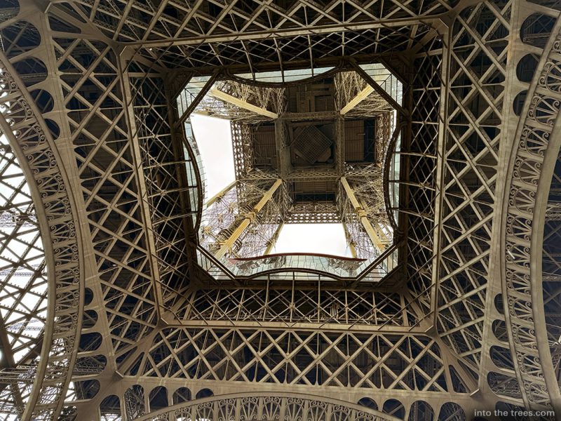 Looking up through the center of the Eiffel Tower.